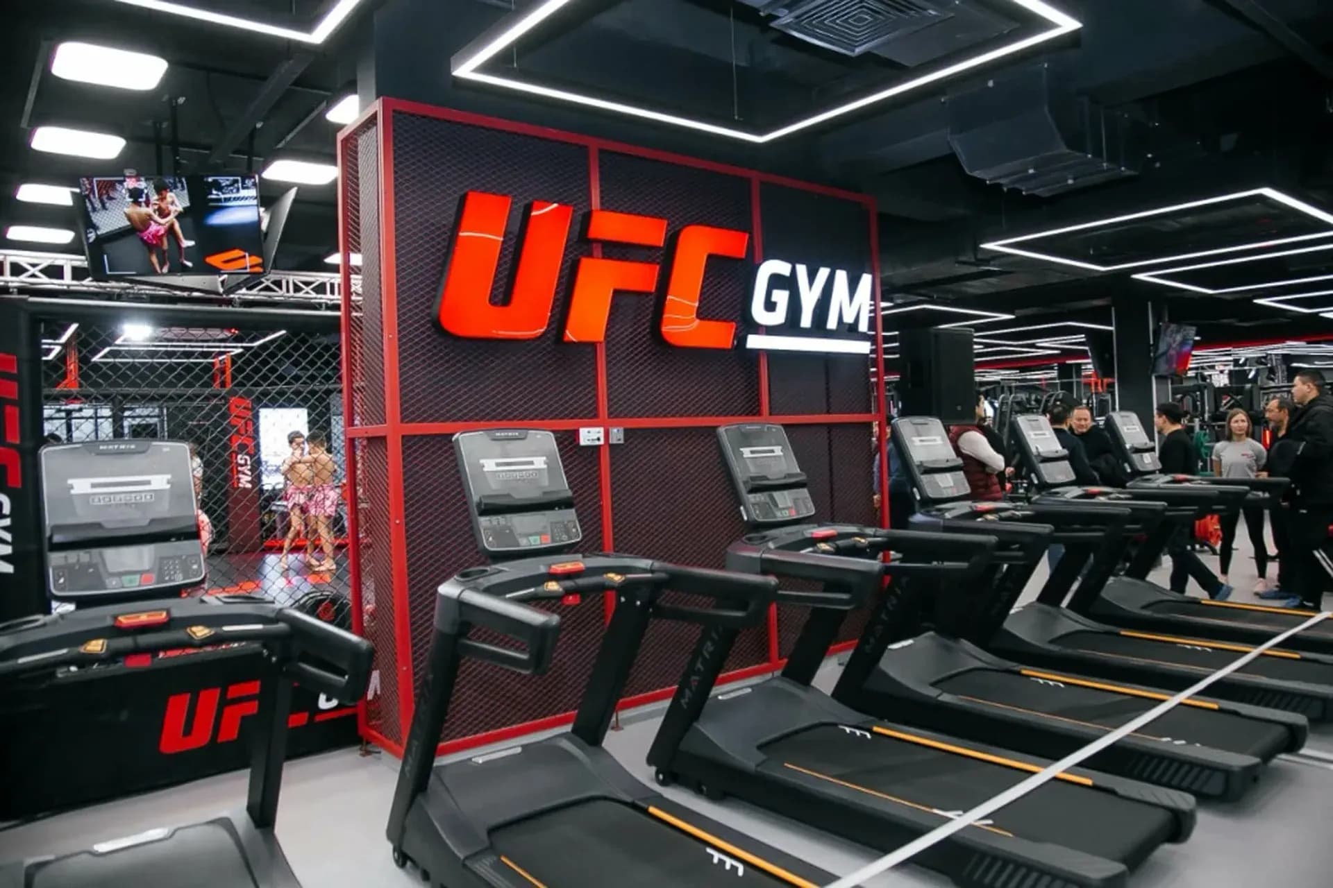 Intérieur d'un club UFC GYM avec la signalétique de la marque